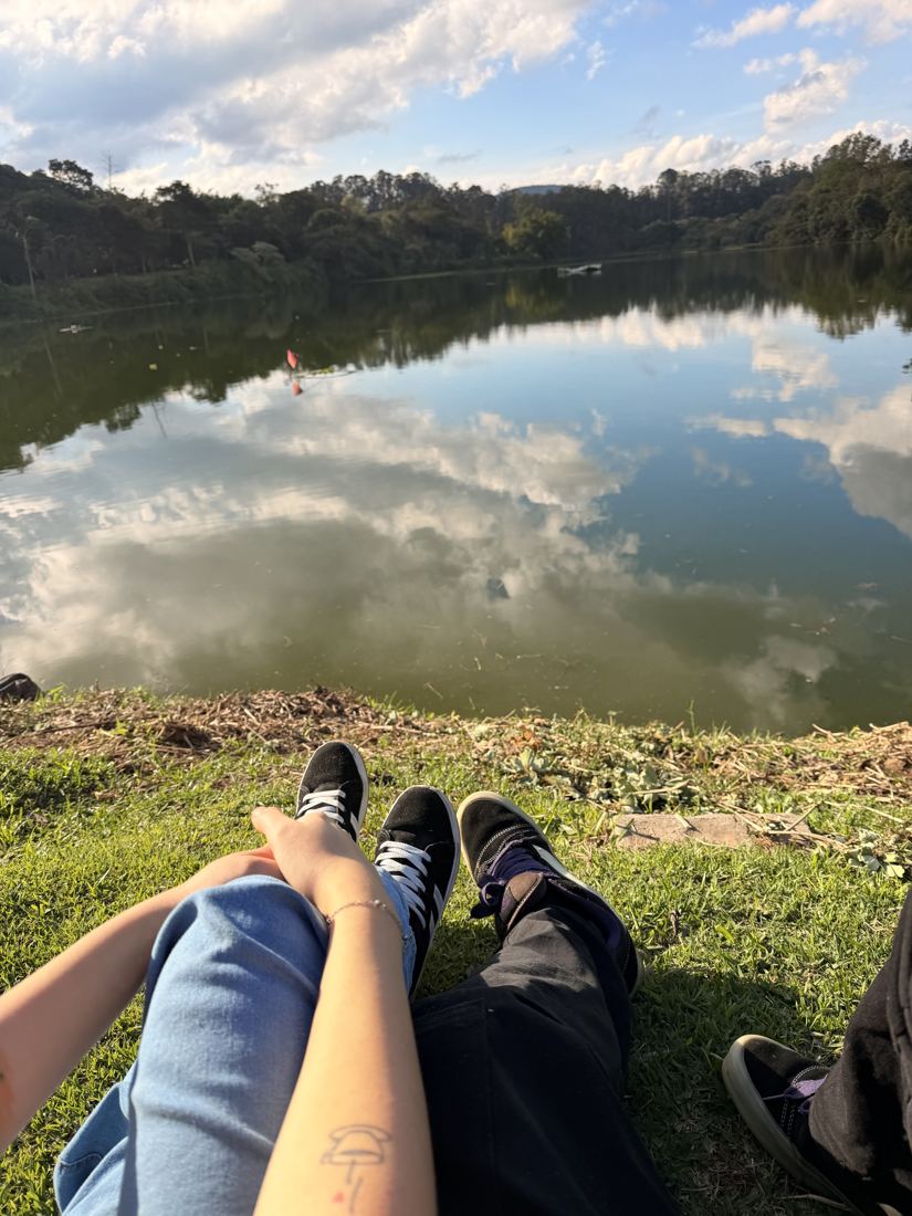 Nossas pernas juntas na beira de um lago